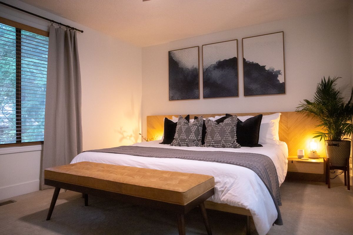 Bedroom 1 with a king bed, leather bench and mountain prints