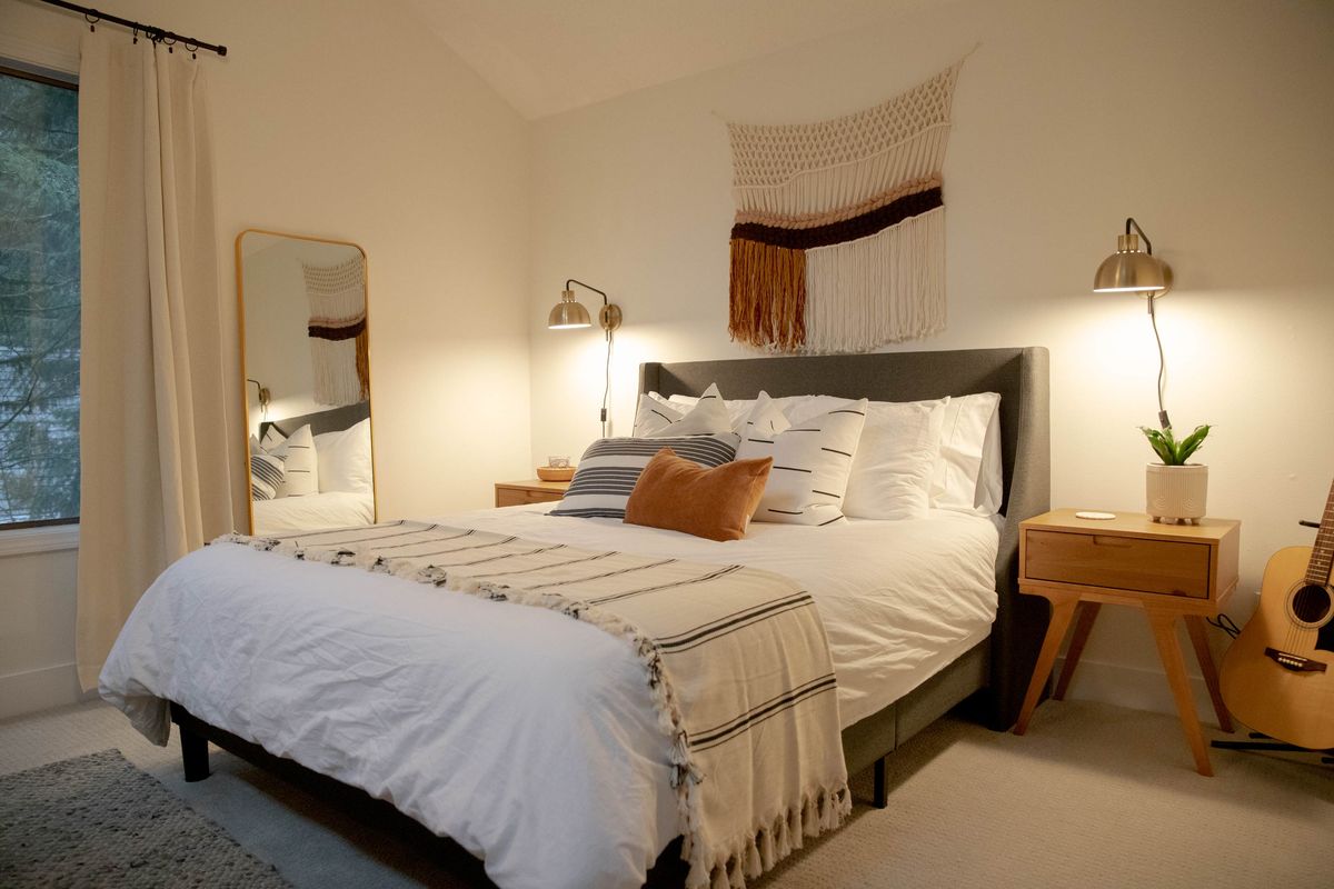 Bedroom 2 with a queen bed and woven wall hanging