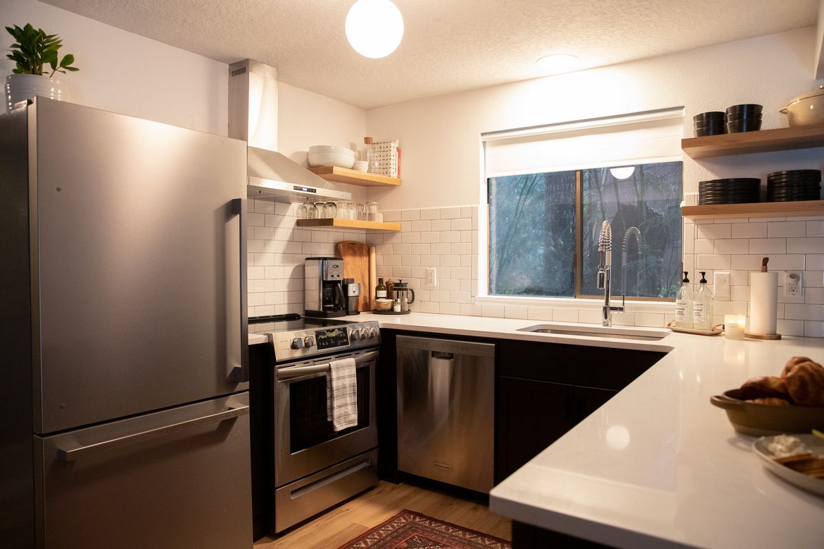 Kitchen counters, gas range and window over the sink